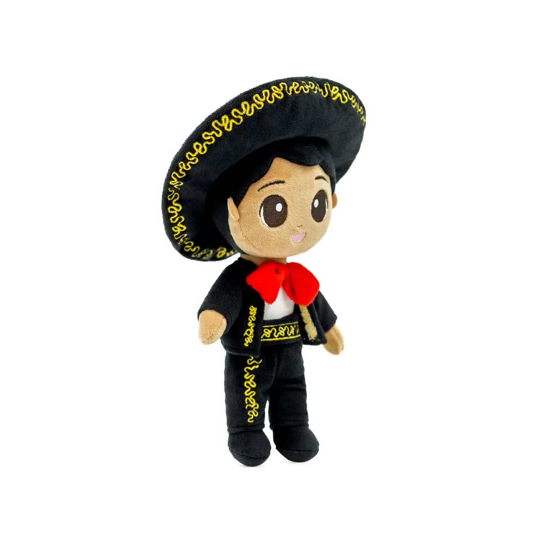 A plush cultural doll with a large black hat, black outfit, and red bandana, designed to celebrate diversity and inspire young minds.