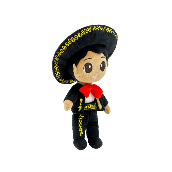 A plush cultural doll with a large black hat, black outfit, and red bandana, designed to celebrate diversity and inspire young minds.