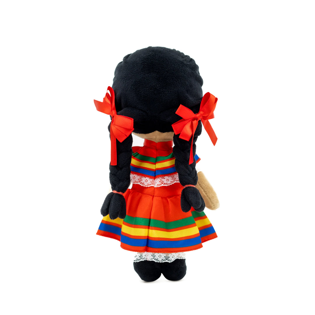 Plush doll with black curled hair, red ribbons, and colorful traditional dress representing diverse cultures.