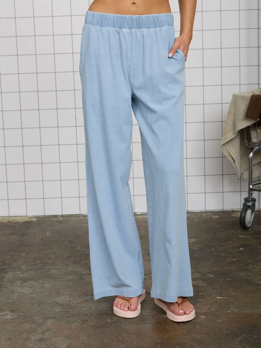 Light blue, wide-leg knit lounge pants with an elastic waistband, in a casual, comfortable style.