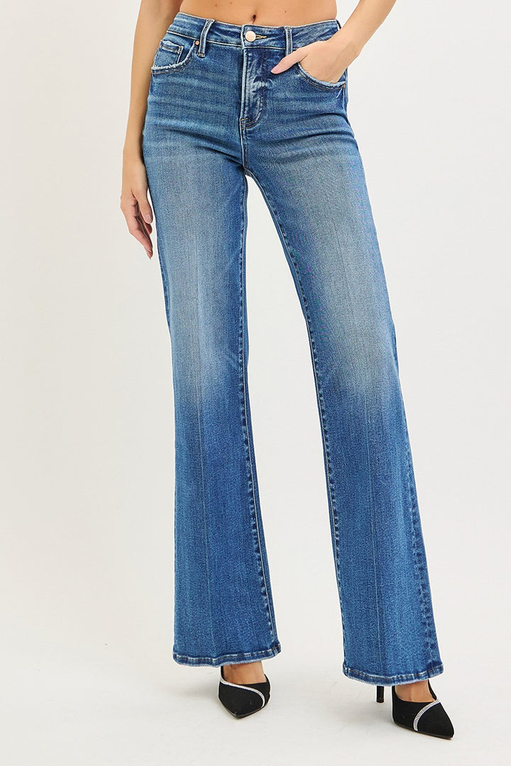 A pair of high-rise, wide-flare denim jeans in a medium blue wash, featuring a tummy control design for a flattering fit.