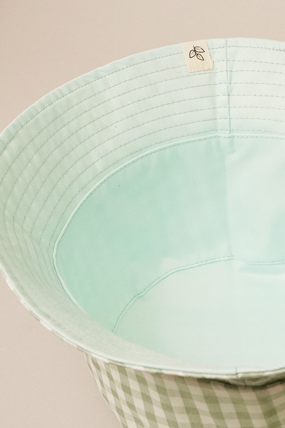 Mint green reversible bucket hat with gingham plaid pattern and 2.25-inch brim, one size fits all.