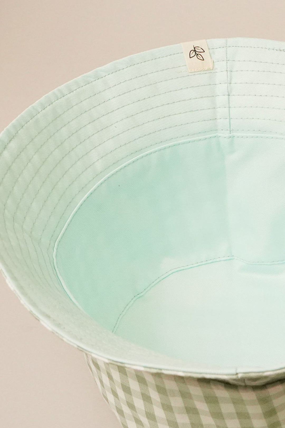 Mint green reversible bucket hat with gingham plaid pattern and 2.25-inch brim, one size fits all.