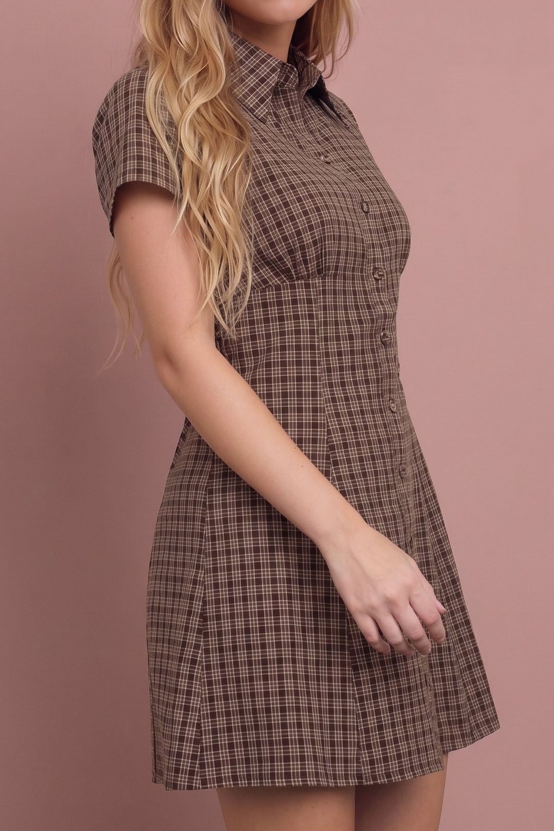 Sasha Plaid Mini Dress in brown check pattern, modeled from side view against pink background.