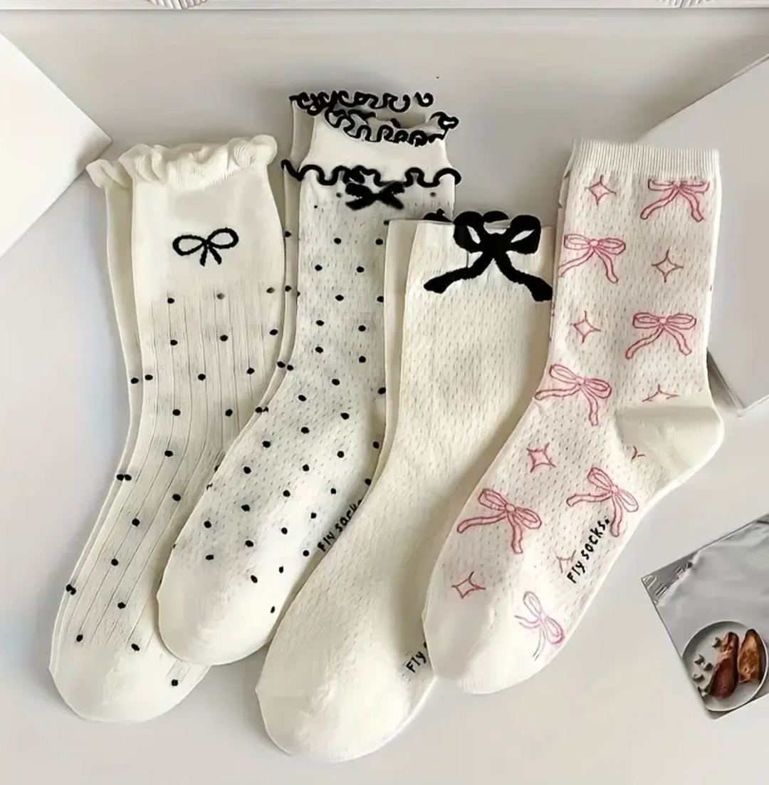 White socks with various bow patterns, polka dots, and Japanese kanji characters printed on them.