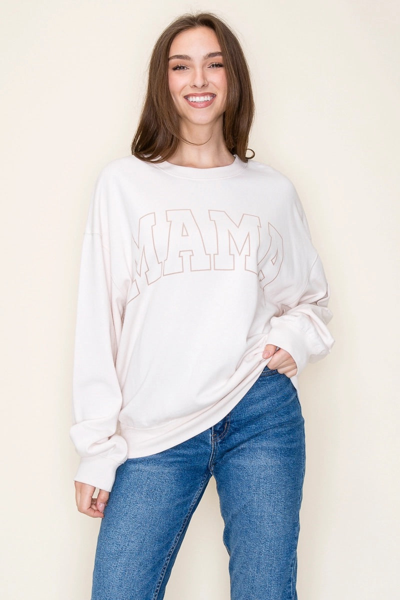 A smiling young woman wearing a white graphic sweatshirt with the text "Miami" displayed prominently, paired with classic blue denim jeans.