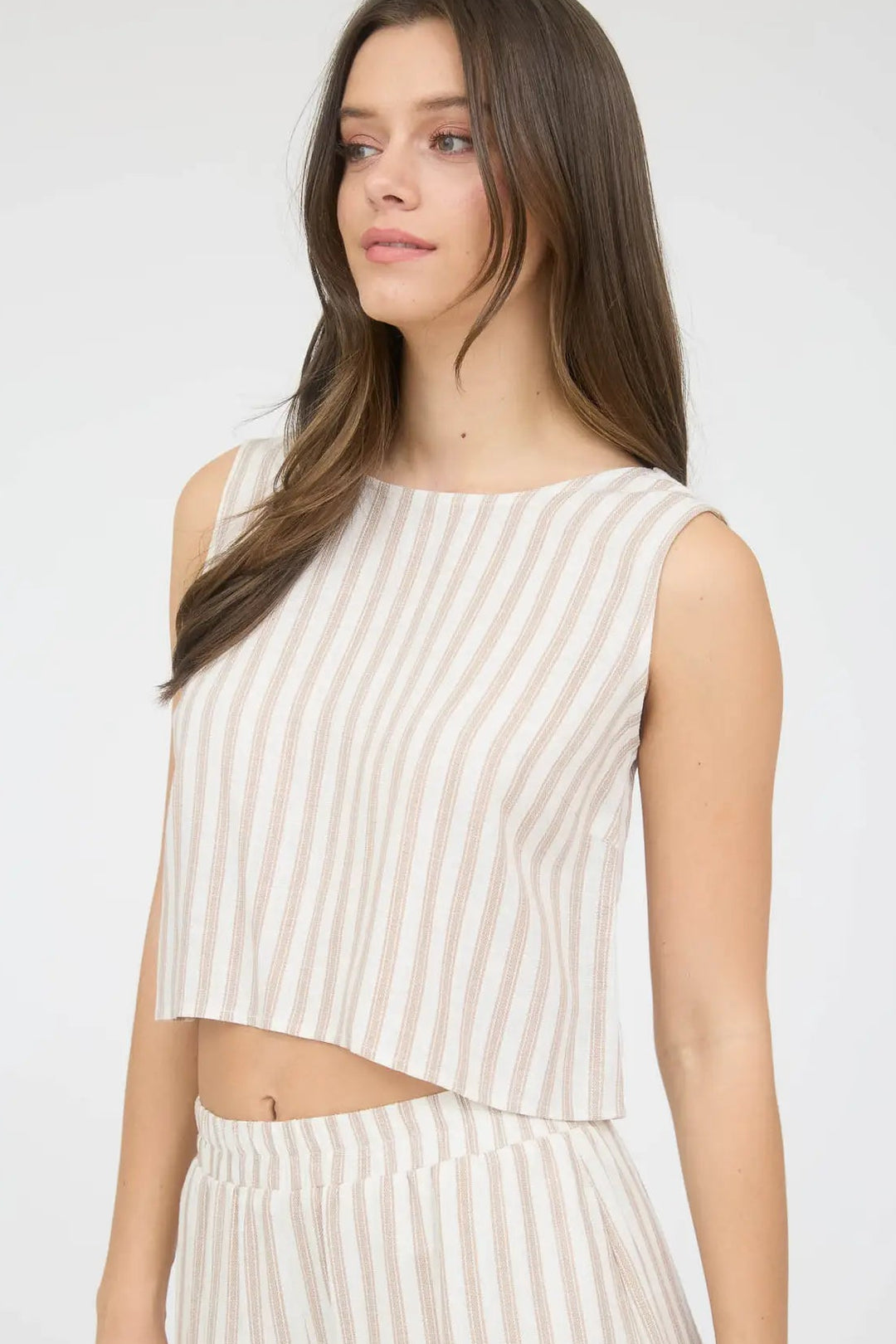 Striped sleeveless crop top with back tie closure, in off-white and tan colors.