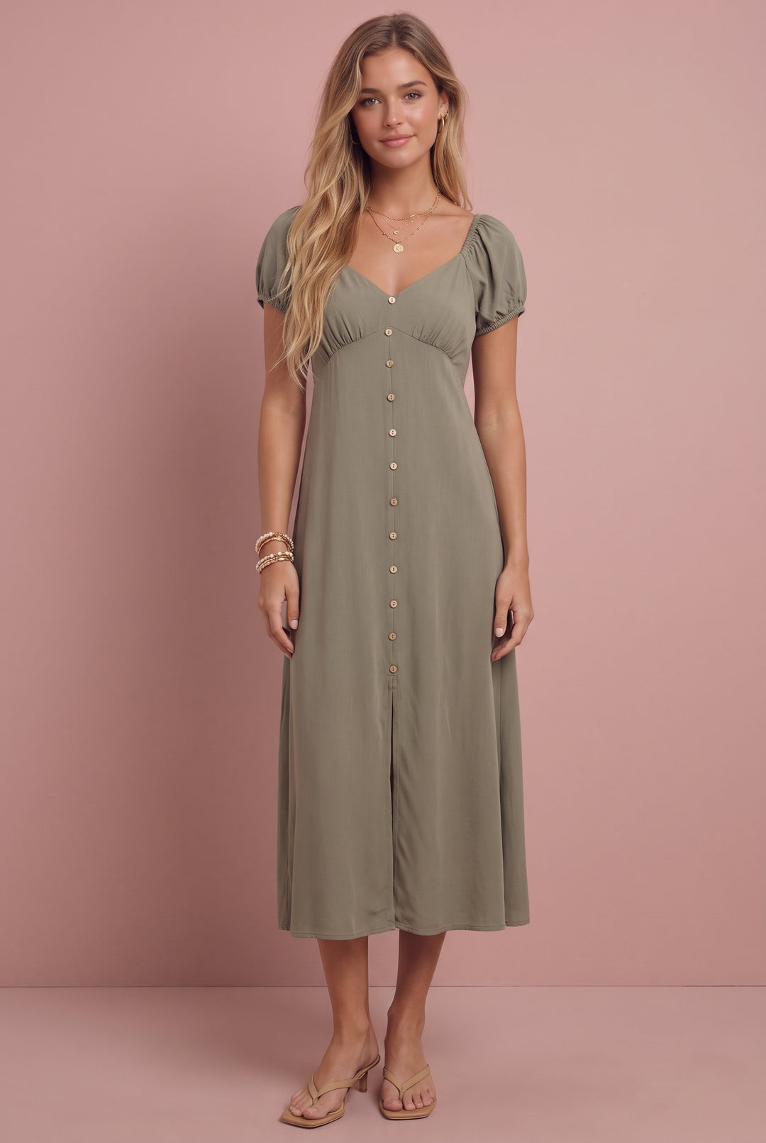 Sage green smocked midi dress with puff sleeves and button front, worn with beige sandals.