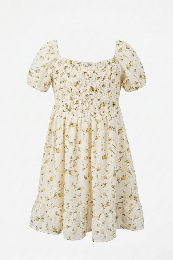 A white dress with a floral print, featuring puff sleeves, a fitted bodice, and a flowing, smocked skirt.