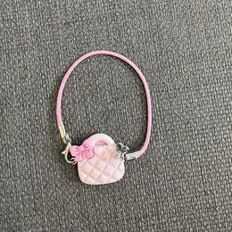 Pink handmade doll headband with a delicate flower detail.