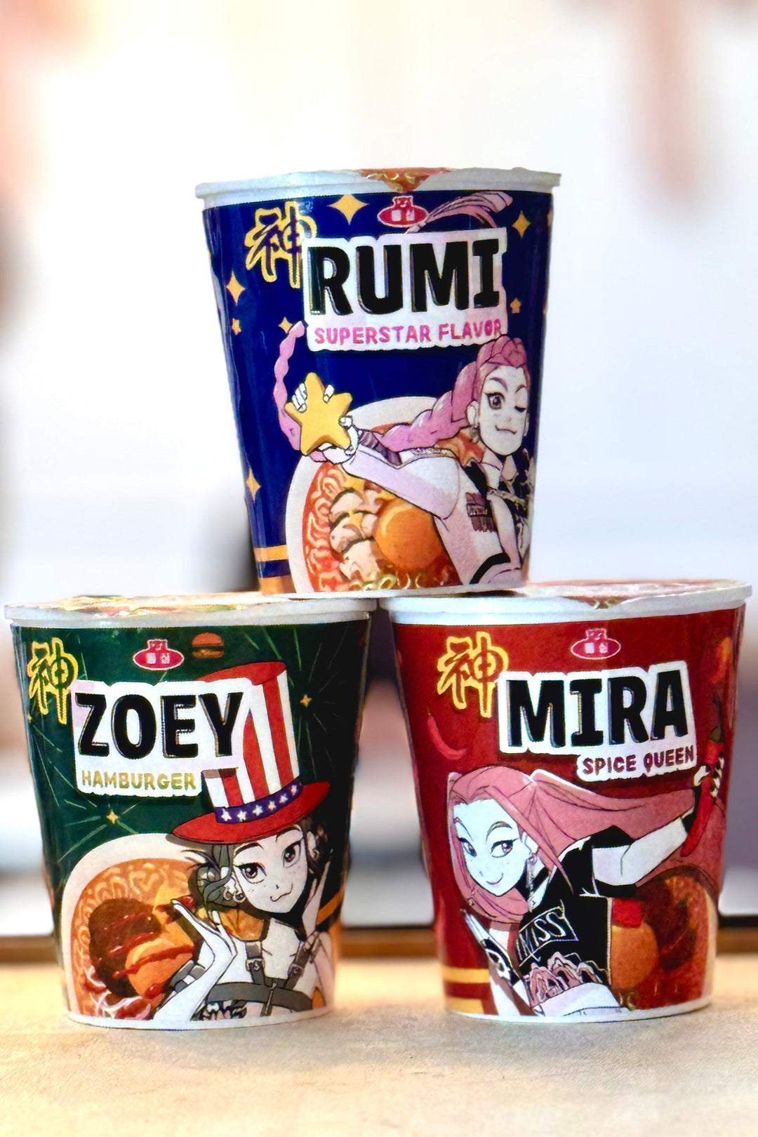 Three cups of Japanese-style ramen noodles featuring bold, anime-inspired graphics and characters in vibrant colors and stylized designs.