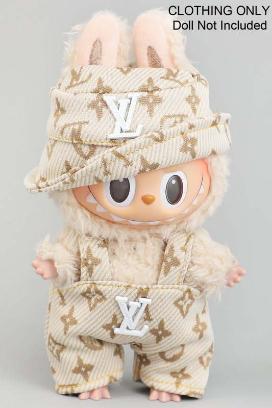 Plush toy doll wearing a beige and gold patterned outfit with an LV logo, including a pom-pom decorated hat.