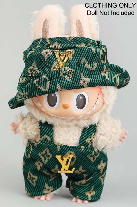 Plush toy wearing green patterned overall and matching hat with Louis Vuitton-inspired design.