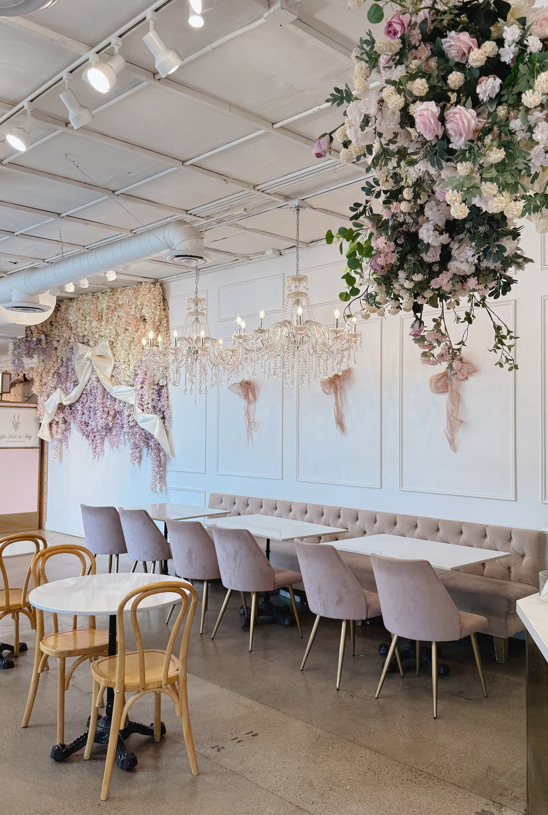 cafe interior with soft colors, soft chairs, and marble tables.