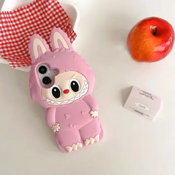 A pink, plush Labubu-shaped phone case with large cartoon eyes and ear details.