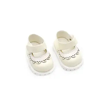 Handcrafted beige leather Mary Jane shoes with decorative cut-outs for dolls.