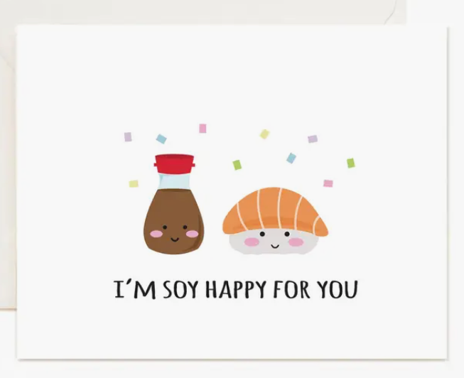 Whimsical greeting card featuring a smiling soy sauce bottle and croissant with text "I'm soy happy for you" and colorful confetti.